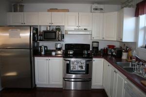 My kitchen, pink counters and all. As you can see, it is dedicated to making coffee!