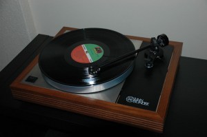 A record player with an album on it - notice the small spindle in the centre that you put the record on. (Photo; lockestreetaudio.com)