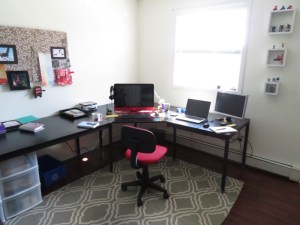 Desk, chair, computers, window, bulletin board