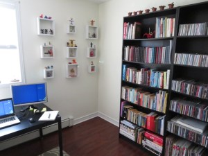 Empty corner of room with robot collection on wall selves
