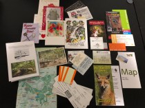 Paper mementos including tickets, greeting cards, tourist pamphlets, boarding passes and maps