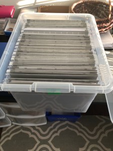 Plastic box full of grey file folders